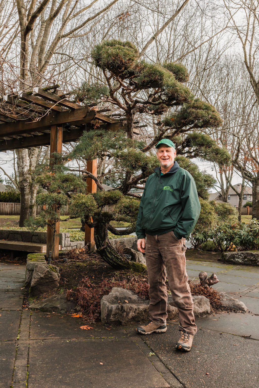 Nathan Lawrence standing by pine tree he pruned Japanese Niwaki Style